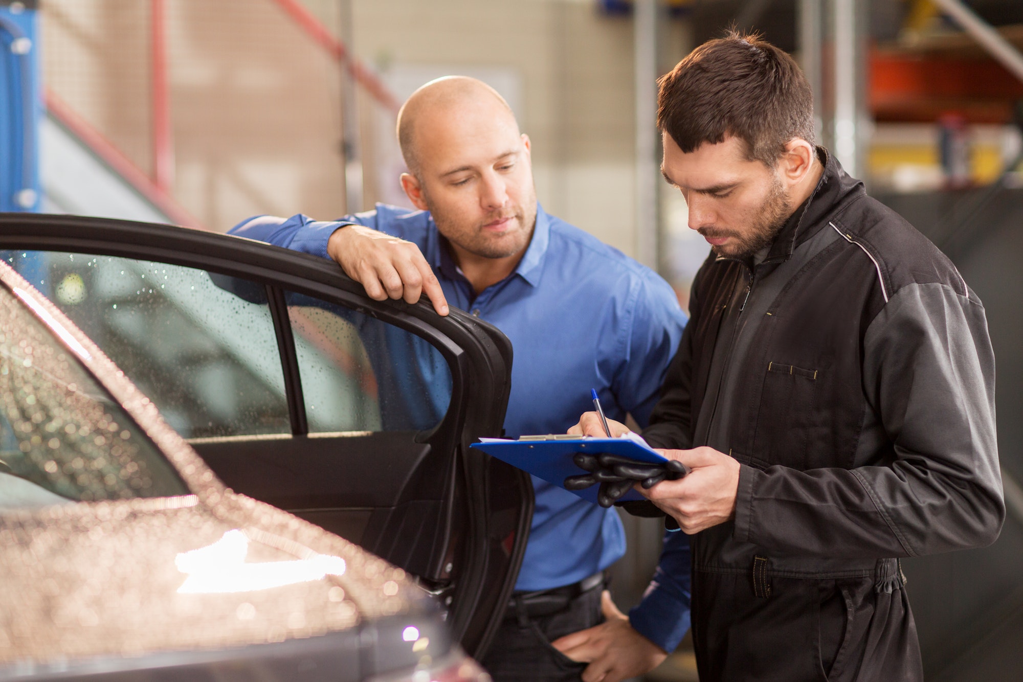 auto mechanic and customer at car shop