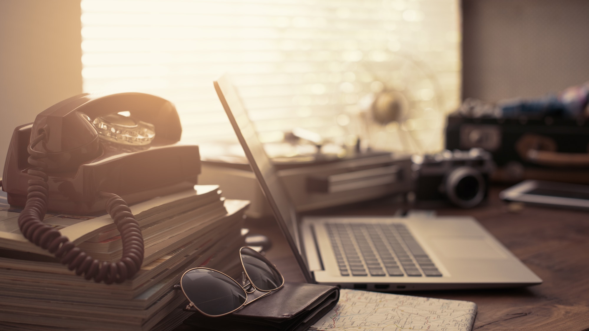 Vintage desktop with laptop and suitcase