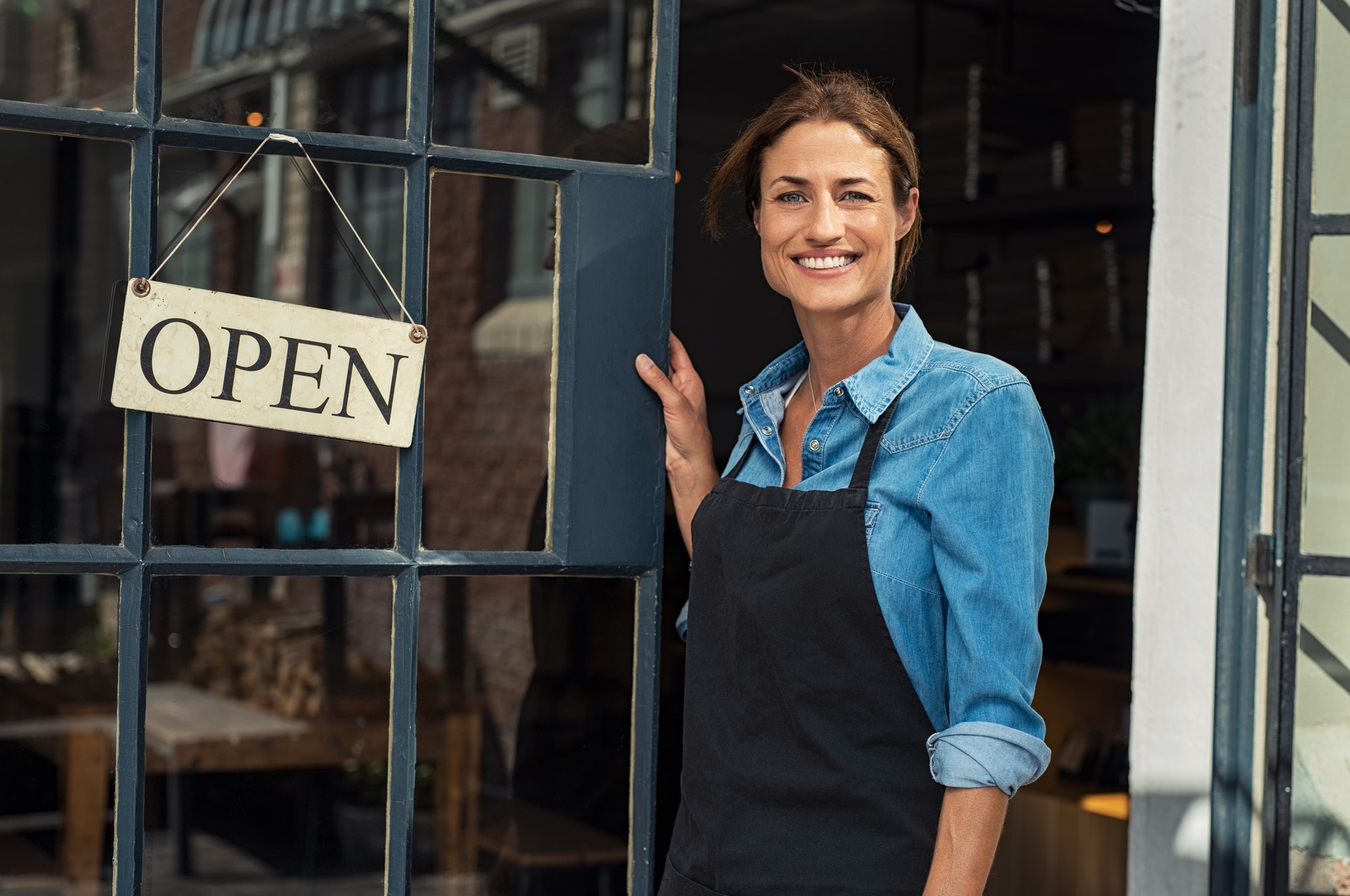 Woman at small business entrance